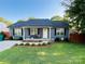 Charming one story home featuring a well-manicured lawn and beautiful landscaping at 1723 Lowder St, Albemarle, NC 28001