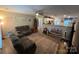 Open concept living room with plush reclining sofa and seamless flow into the kitchen at 1723 Lowder St, Albemarle, NC 28001