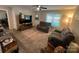 Bright living room features neutral walls, large window and reclining sofa set at 1723 Lowder St, Albemarle, NC 28001