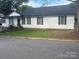 Lovely home with black shutters and a well-manicured lawn, providing a classic and inviting curb appeal at 210 W Church St, Cherryville, NC 28021