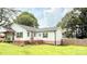 A classic home with white siding, contrasted by dark shutters and complemented by a lush, green lawn at 210 W Church St, Cherryville, NC 28021