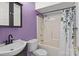 Full bathroom with purple walls, a shower-tub combo with stylish curtain, and a vanity sink at 2268 Bay Ct, Newton, NC 28658
