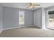 Bedroom featuring neutral walls, carpet, ceiling fan, and closet and deck access at 2268 Bay Ct, Newton, NC 28658