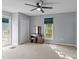 Bedroom with carpet, ceiling fan, closet, vanity, and deck access through a glass door at 2268 Bay Ct, Newton, NC 28658
