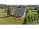 Serene one-story home nestled among mature trees, showcasing a gray exterior and a well-maintained lawn at 2268 Bay Ct, Newton, NC 28658