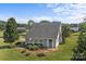 Cozy one-story home surrounded by lush greenery, with a charming gray exterior and ample yard space at 2268 Bay Ct, Newton, NC 28658
