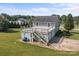Rear view of home displays the deck, siding, and mature trees at 2268 Bay Ct, Newton, NC 28658