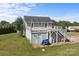 Back of home displays a deck and lawn area, with mature shade trees at 2268 Bay Ct, Newton, NC 28658