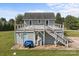 View of the house exterior featuring a large wooden deck with metal railing and stairs at 2268 Bay Ct, Newton, NC 28658