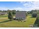 Quaint one-story home surrounded by a lush green lawn, mature trees, and a basketball hoop at 2268 Bay Ct, Newton, NC 28658