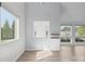 Bright living room features sleek floors, fresh paint, and natural light from the large windows, offering modern comfort and style at 2268 Bay Ct, Newton, NC 28658