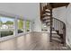 Bright living room features a spiral staircase, large windows, and sleek floors, offering modern comfort and style at 2268 Bay Ct, Newton, NC 28658