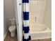 Bathroom boasts a convenient toilet and shower-tub combo with stylish blue-striped curtain at 2289 Kestrel Dr, Rock Hill, SC 29732