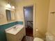 Bathroom with blue tile accent, white cabinets, a sink, and a stairway view at 250 Nixon Rd # 41, Belmont, NC 28012