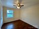 Bedroom with hardwood floors, ceiling fan, neutral walls, and a window at 250 Nixon Rd # 41, Belmont, NC 28012