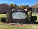Welcoming sign for Southwood Arms Condominiums, enhanced by blooming yellow roses and greenery at 250 Nixon Rd # 41, Belmont, NC 28012