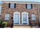 Charming brick townhome featuring black shutters and a well-maintained front entrance with white doors at 250 Nixon Rd # 41, Belmont, NC 28012