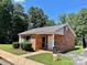Exterior of brick building with 'Laundry Drop-Off' sign and landscaping at 250 Nixon Rd # 41, Belmont, NC 28012