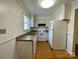 Traditional kitchen featuring a stainless steel sink, white cabinets, and essential appliances at 250 Nixon Rd # 41, Belmont, NC 28012