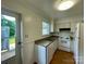 Functional kitchen featuring white appliances, a double sink, and a door leading to the outside at 250 Nixon Rd # 41, Belmont, NC 28012