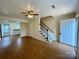 Inviting living room featuring hardwood floors, a ceiling fan, and access to the staircase and kitchen at 250 Nixon Rd # 41, Belmont, NC 28012