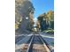 Scenic view of train tracks disappearing into the horizon, framed by lush trees, under a bright, sunny sky at 250 Nixon Rd # 41, Belmont, NC 28012