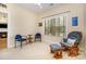 A well-lit bedroom featuring a comfortable rocking chair and a view of the fireplace at 2773 Clover Nw Rd, Concord, NC 28027