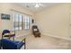 Bedroom with a large window, cozy chairs, and a comfortable rocker with ottoman at 2773 Clover Nw Rd, Concord, NC 28027