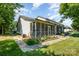 Home featuring a screened porch, manicured flower beds, and a well-kept lawn at 2773 Clover Nw Rd, Concord, NC 28027