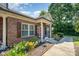 Inviting brick home with a cozy front porch, flower beds, and well-maintained lawn at 2773 Clover Nw Rd, Concord, NC 28027