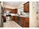 Efficient kitchen boasting stainless steel appliances, wood cabinetry, and tiled floors at 2773 Clover Nw Rd, Concord, NC 28027