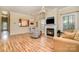 Bright living room with fireplace, hardwood floors, and a cozy seating area at 2773 Clover Nw Rd, Concord, NC 28027
