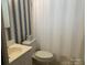 Bathroom features a patterned wallpaper, sink, toilet and a shower with curtain at 3009 Grier St, Newton, NC 28658