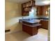 Retro kitchen with a window, wooden cabinets, peninsula and laminate countertops at 3009 Grier St, Newton, NC 28658
