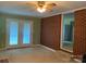 This is a cozy living room with brick accent wall, ceiling fan and French doors at 3009 Grier St, Newton, NC 28658