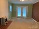 Cozy living room with fireplace, brick accent wall and french doors at 3009 Grier St, Newton, NC 28658