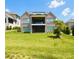 Spacious backyard with lush lawn and view of the back of the brick home, with covered porch at 3011 Ella Katherine Way, Charlotte, NC 28210