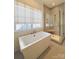 Luxurious bathroom featuring a soaking tub, glass-enclosed shower, and modern fixtures at 3011 Ella Katherine Way, Charlotte, NC 28210