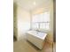 Bright bathroom featuring a sleek standalone tub underneath a window with a neutral color palette at 3011 Ella Katherine Way, Charlotte, NC 28210