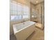 Bright bathroom featuring a soaking tub and glass-enclosed shower at 3011 Ella Katherine Way, Charlotte, NC 28210