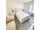Bright bedroom with a stylish bed, accent chair, ottoman, and patterned area rug at 3011 Ella Katherine Way, Charlotte, NC 28210