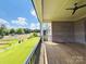 Spacious covered deck with a ceiling fan overlooking a lush backyard at 3011 Ella Katherine Way, Charlotte, NC 28210