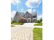 Beautiful brick two-story home with an attached garage and a spacious driveway under a bright sky at 3011 Ella Katherine Way, Charlotte, NC 28210