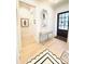 Inviting foyer featuring light wood floors, decorative table, mirror, and stylish black and white rug at 3011 Ella Katherine Way, Charlotte, NC 28210