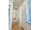 Hallway featuring hardwood flooring, storage cabinets, and white trim at 3011 Ella Katherine Way, Charlotte, NC 28210