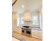Stylish kitchen features stainless steel range with a white hood and sleek white cabinetry at 3011 Ella Katherine Way, Charlotte, NC 28210