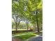 Serene street view featuring mature trees, landscaped green space, and a quaint gazebo at 3011 Ella Katherine Way, Charlotte, NC 28210