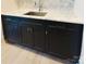 Wet bar with marble counter, stainless steel sink, and dark cabinets at 3011 Ella Katherine Way, Charlotte, NC 28210