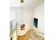 View of a bright staircase with white railings, hardwood steps, modern chandelier, and wall art at 3011 Ella Katherine Way, Charlotte, NC 28210