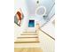 Bright staircase featuring wood treads, white risers, and modern lighting fixture at 3011 Ella Katherine Way, Charlotte, NC 28210